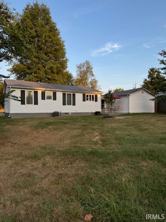 rear view of property with a yard