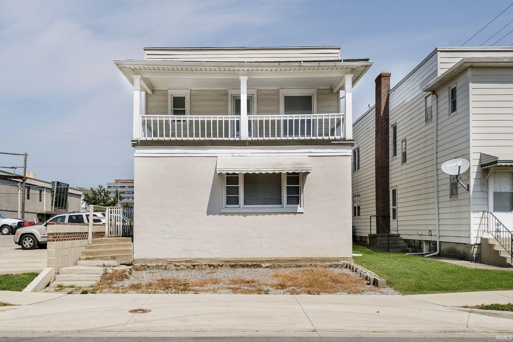 view of front facade with a balcony