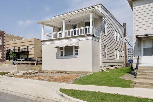 view of front of house featuring a balcony