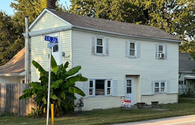 view of front of house with cooling unit and a front yard