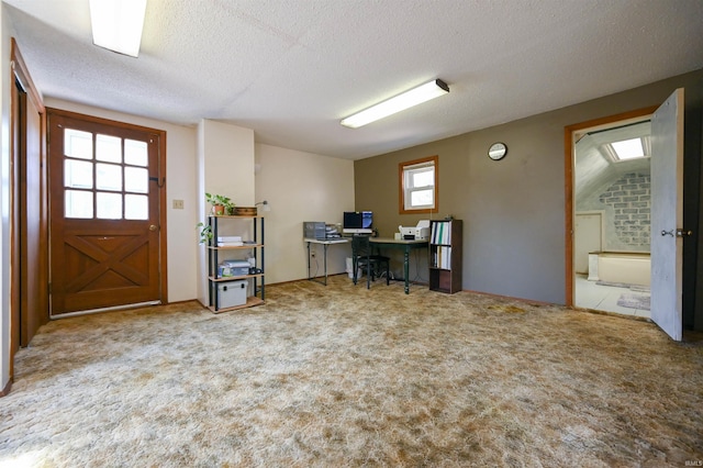 foyer featuring a textured ceiling and carpet flooring