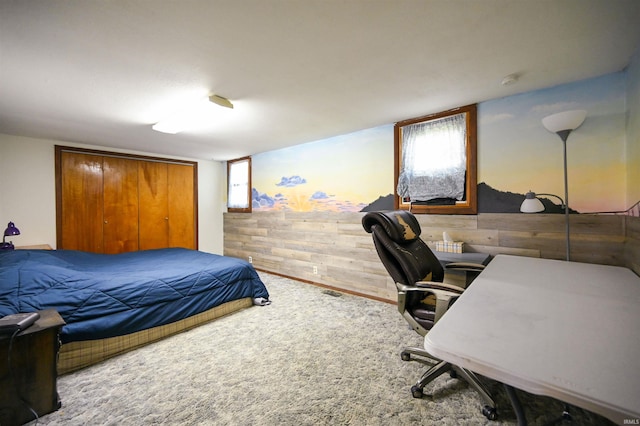 bedroom featuring a closet and wood walls