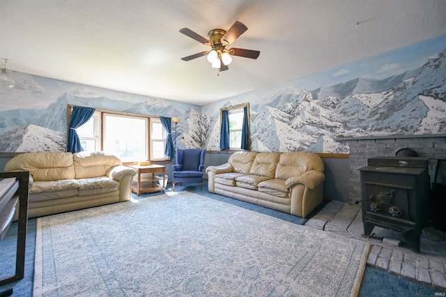 carpeted living room with a textured ceiling, ceiling fan, and a wood stove