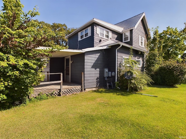 back of house with a yard and a wooden deck