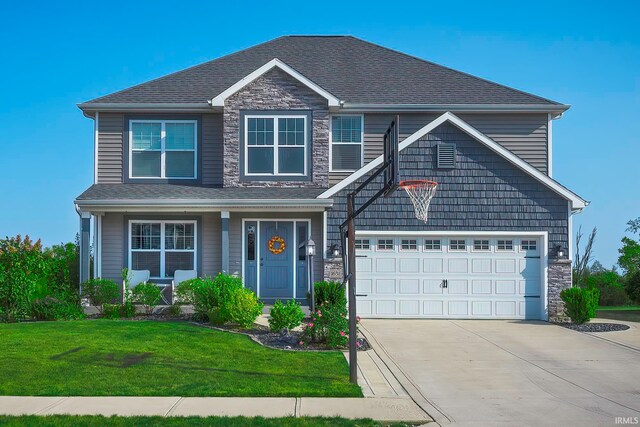 view of front of house featuring a front yard and a garage