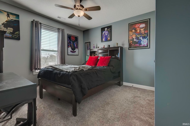 bedroom featuring a textured ceiling, carpet flooring, and ceiling fan