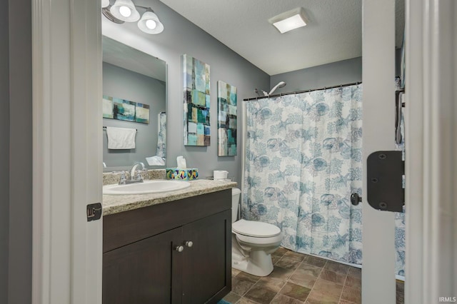 bathroom with vanity, toilet, a textured ceiling, and a shower with curtain