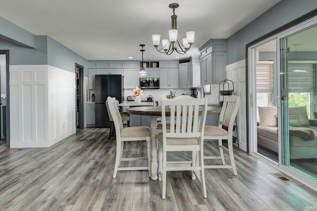 dining room featuring an inviting chandelier and light wood-type flooring