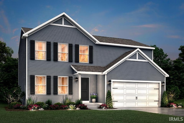 view of front property with a yard and a garage