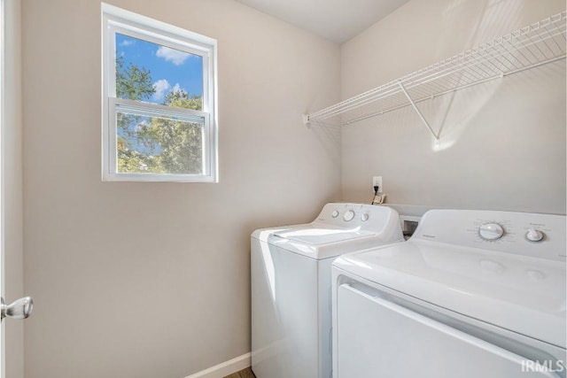 clothes washing area featuring washer and clothes dryer