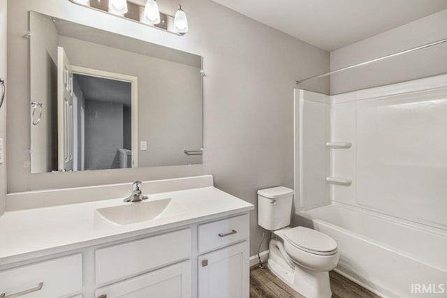 full bathroom featuring hardwood / wood-style flooring, vanity, shower / bathtub combination, and toilet