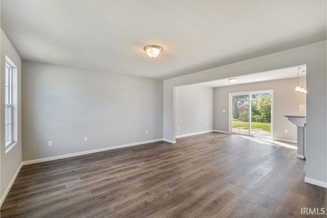 unfurnished living room with dark hardwood / wood-style floors