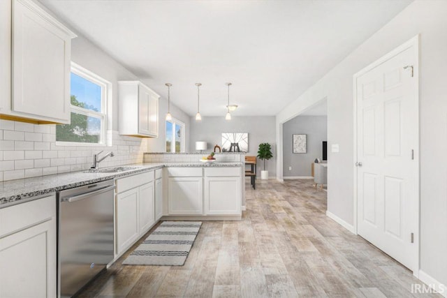 kitchen featuring white cabinetry, stainless steel dishwasher, decorative light fixtures, and kitchen peninsula