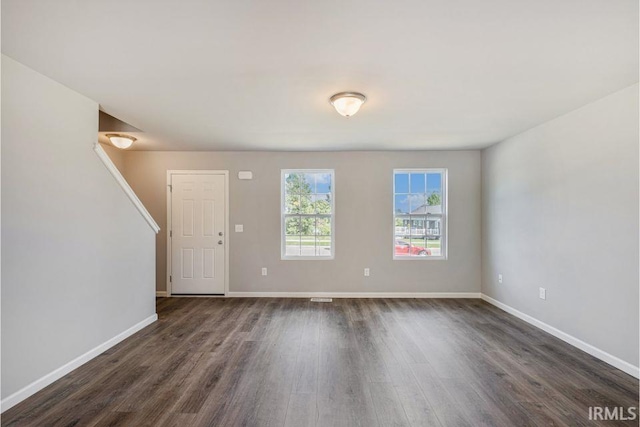 entryway with dark hardwood / wood-style flooring