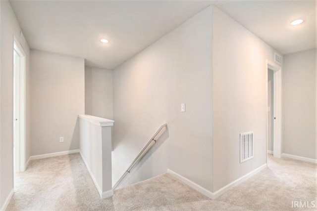 hallway with light colored carpet