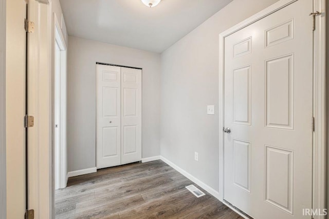 unfurnished bedroom featuring light wood-type flooring and a closet