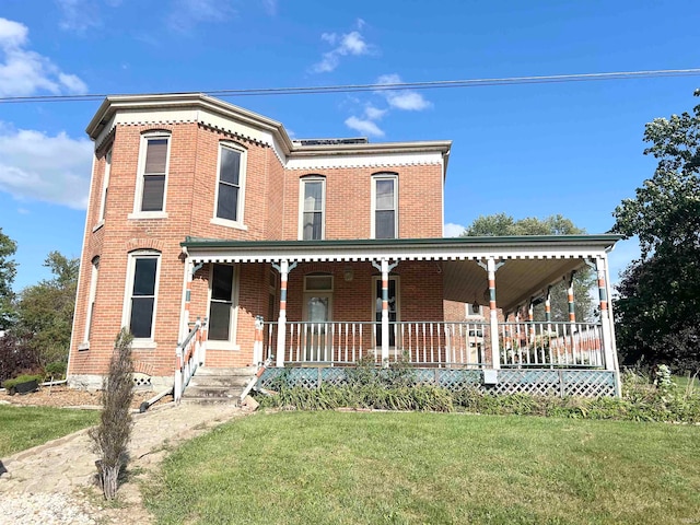 view of front of property featuring covered porch and a front yard