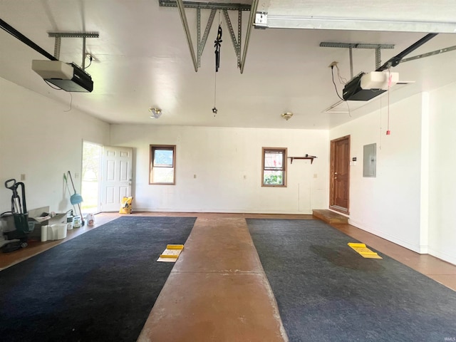 garage with electric panel and a garage door opener