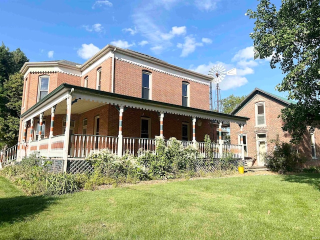 rear view of property with a lawn