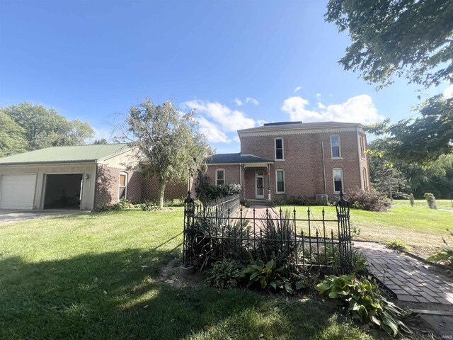 view of front of house with a front yard and a garage