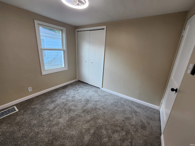 unfurnished bedroom featuring carpet floors and a closet