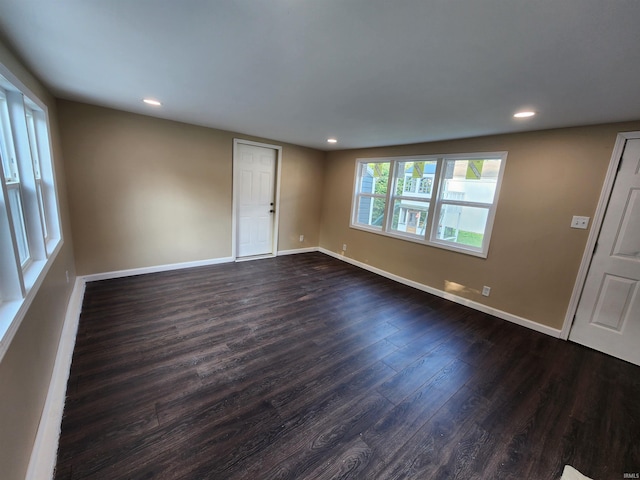 unfurnished room featuring dark wood-type flooring