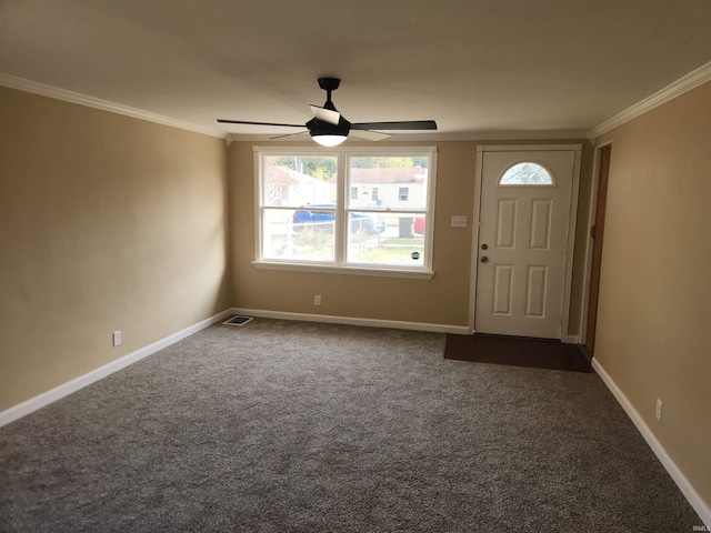 carpeted foyer entrance with ceiling fan and ornamental molding