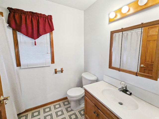 bathroom featuring vanity and toilet