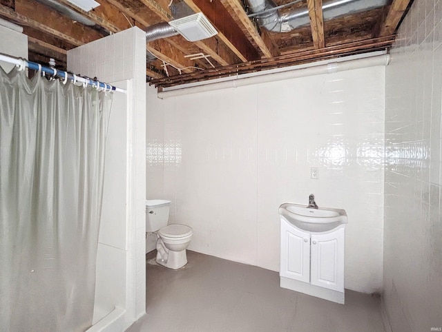 bathroom featuring vanity, toilet, a shower with shower curtain, and concrete flooring