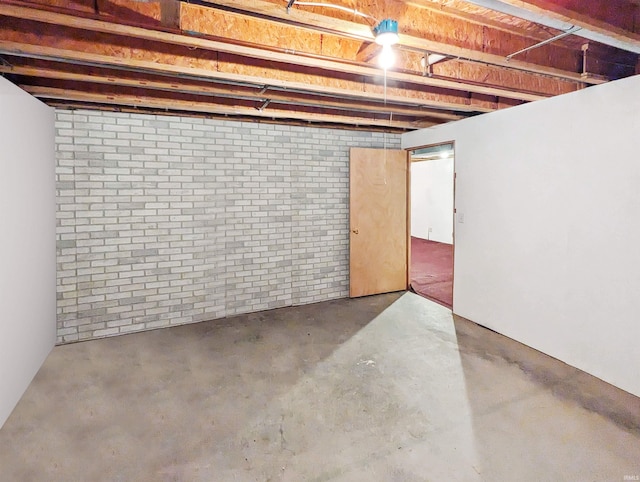 basement with brick wall