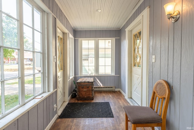 sunroom with a wealth of natural light, baseboard heating, and wood ceiling