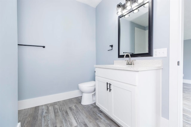 bathroom featuring hardwood / wood-style floors, vanity, and toilet