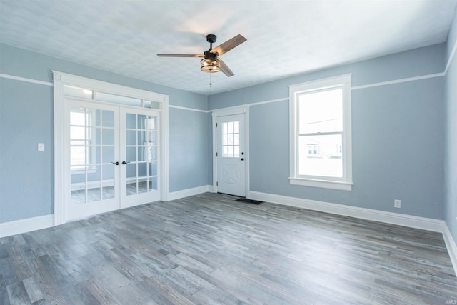 interior space with ceiling fan, french doors, and wood-type flooring