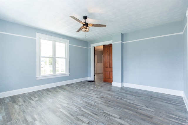 spare room featuring hardwood / wood-style flooring and ceiling fan