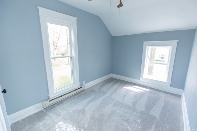 bonus room featuring vaulted ceiling, baseboard heating, and a healthy amount of sunlight