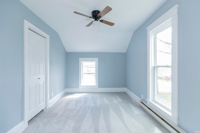 bonus room with baseboard heating, ceiling fan, light colored carpet, and lofted ceiling