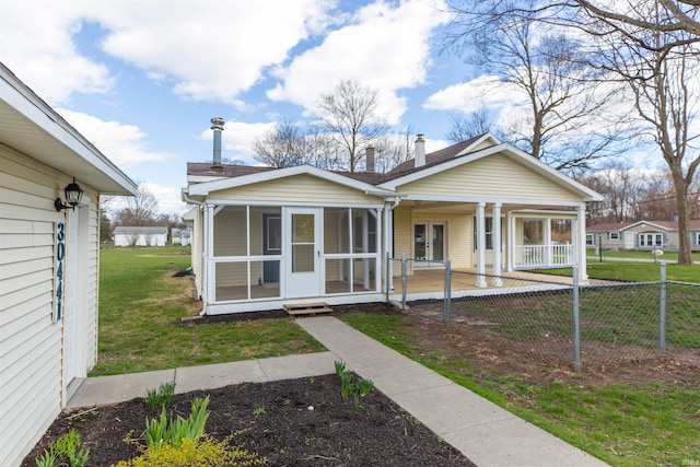 rear view of property with a lawn and french doors