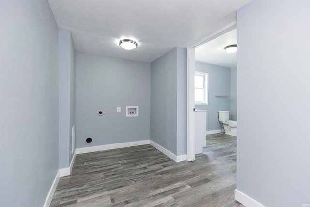 clothes washing area with hookup for a washing machine, dark hardwood / wood-style flooring, and hookup for an electric dryer