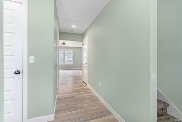 3615 Lindbergh Blvd, Fort Wayne, IN 46806 - hall featuring baseboards, light wood-type flooring, recessed lighting, and a textured ceiling