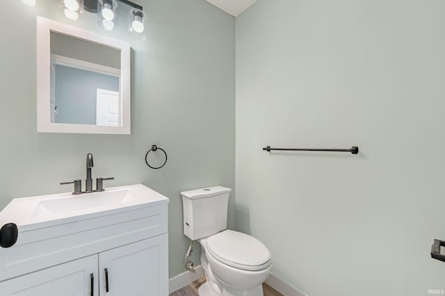 3615 Lindbergh Blvd, Fort Wayne, IN 46806 - bathroom with toilet, vanity, wood finished floors, and baseboards