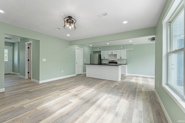 3615 Lindbergh Blvd, Fort Wayne, IN 46806 - unfurnished living room featuring light wood-style floors, baseboards, and recessed lighting
