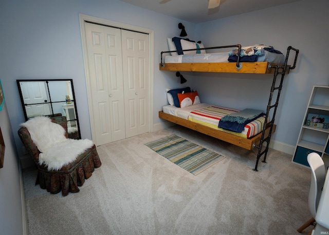 bedroom with light carpet, ceiling fan, and a closet