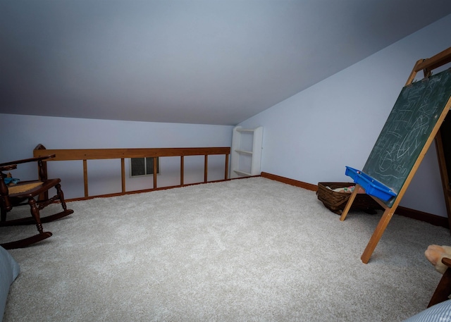 living area featuring vaulted ceiling and carpet flooring