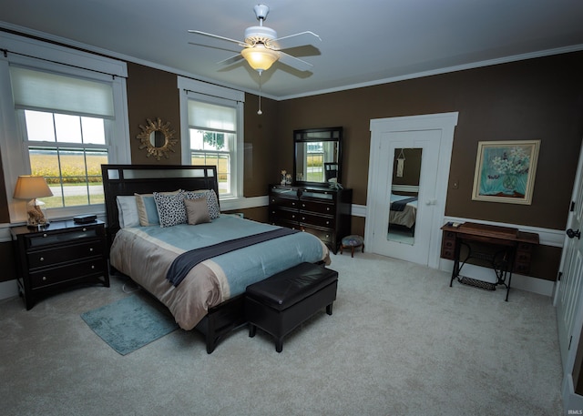 bedroom with ceiling fan, crown molding, and light carpet