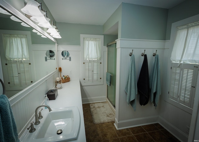 bathroom featuring vanity, walk in shower, and tile patterned floors