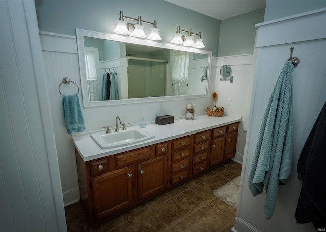 bathroom with tile patterned floors, an enclosed shower, and vanity