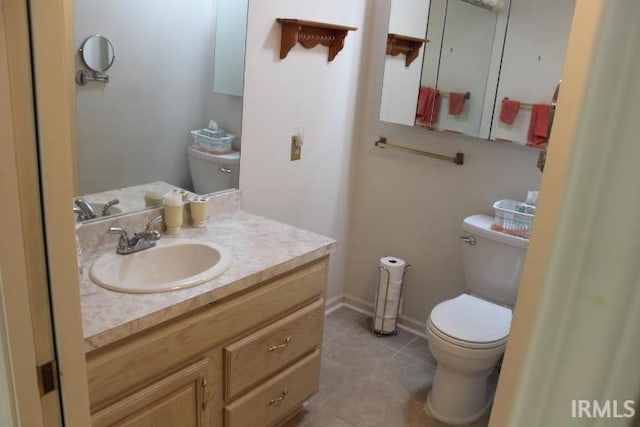 bathroom with vanity, toilet, and tile patterned flooring