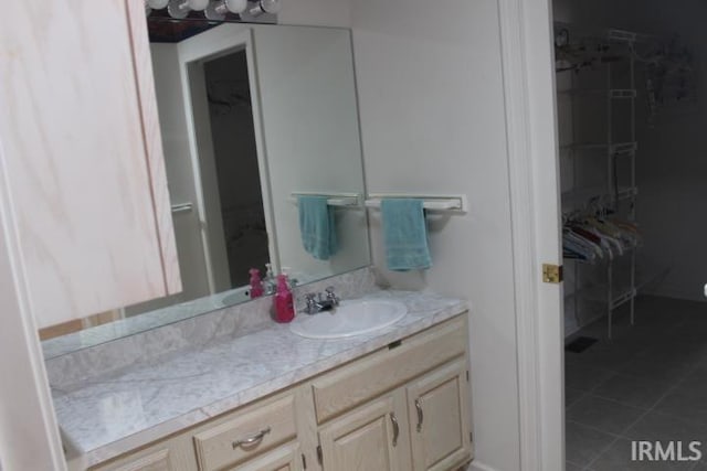 bathroom with tile patterned floors and vanity