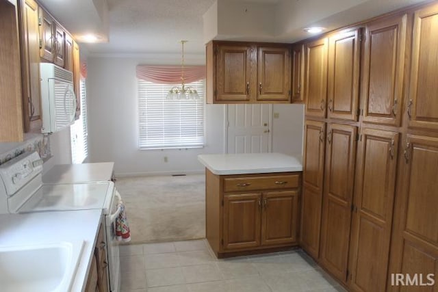 kitchen with white appliances, a chandelier, decorative light fixtures, kitchen peninsula, and light tile patterned flooring