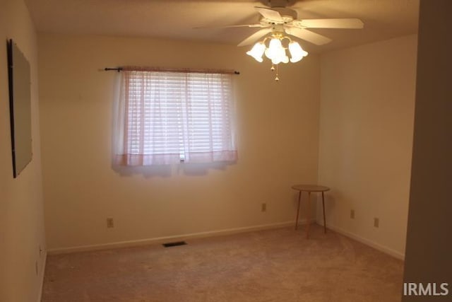 carpeted empty room featuring ceiling fan